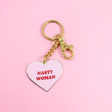 A heart shaped key ring that says nasty woman